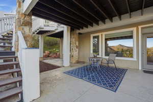 View of patio / terrace with stairs and a mountain view