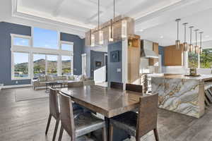 Dining space featuring a mountain view, dark wood finished floors, and high coffered ceiling