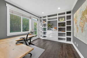 Office area featuring crown molding, built in features, dark wood-type flooring, and recessed lighting