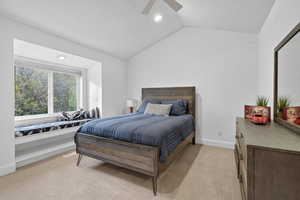 Bedroom featuring light colored carpet, lofted ceiling, ceiling fan, and recessed lighting