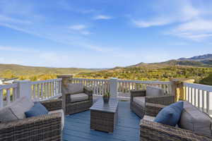 Wooden terrace with an outdoor living space and a mountain view