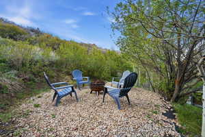 View of yard with a fire pit and a patio