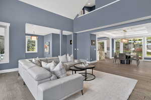 Living room with hardwood / wood-style flooring and lofted ceiling