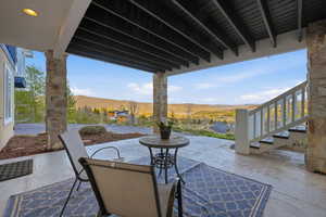 View of patio featuring a mountain view and stairway