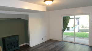 Bed room featuring a textured ceiling and dark wood finished floors