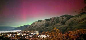 Desirable, Beautiful Mountainous terrain framing a city at night