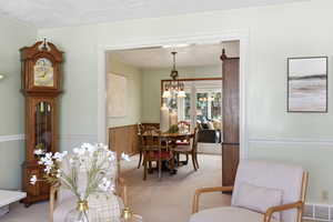 Dining space with light colored carpet