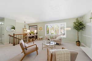 Carpeted living room with baseboards