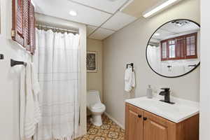 Full bath with vanity, light tile patterned floors, a paneled ceiling, curtained shower, and recessed lighting