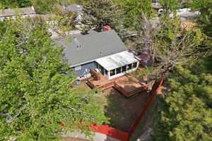 View of subject property featuring a tree filled landscape