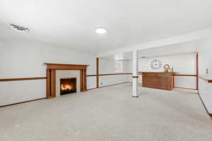 Basement family room with fireplace and wet bar.