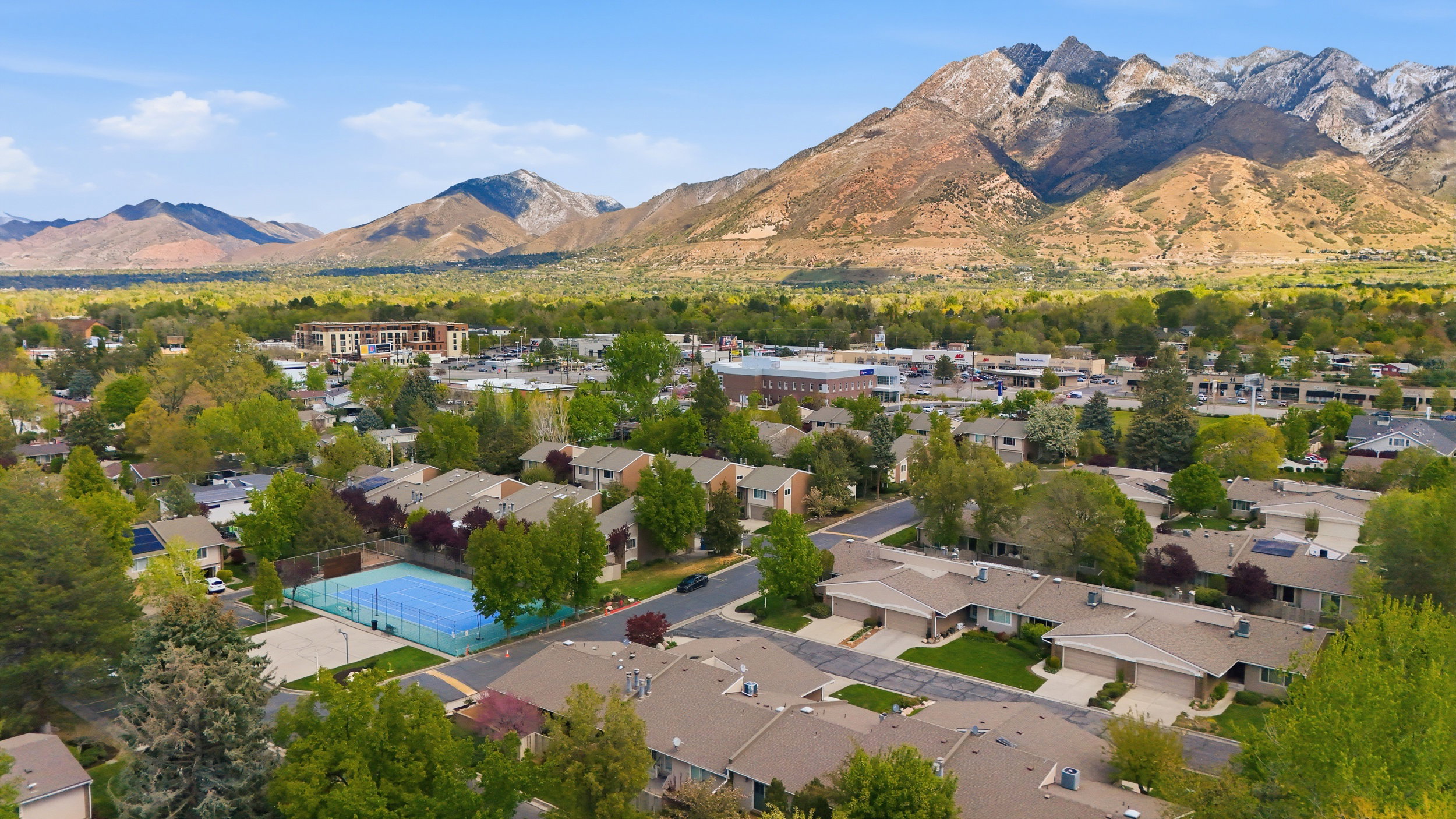 Aerial view of residential area featuring a mountainous background