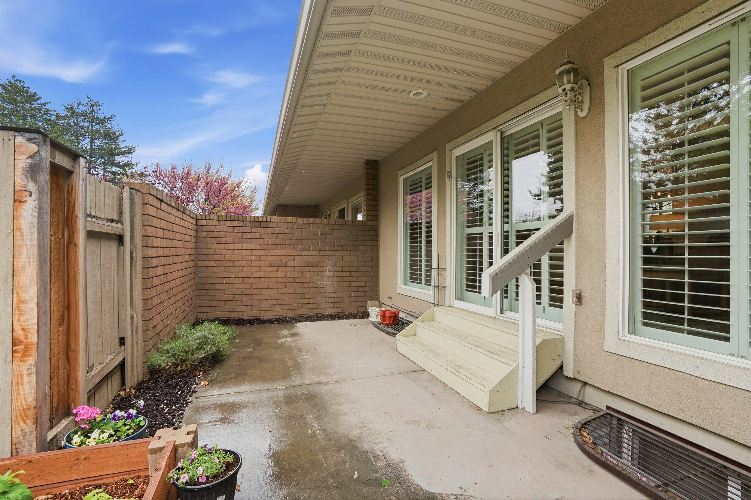 Fenced backyard with a patio area and entry steps