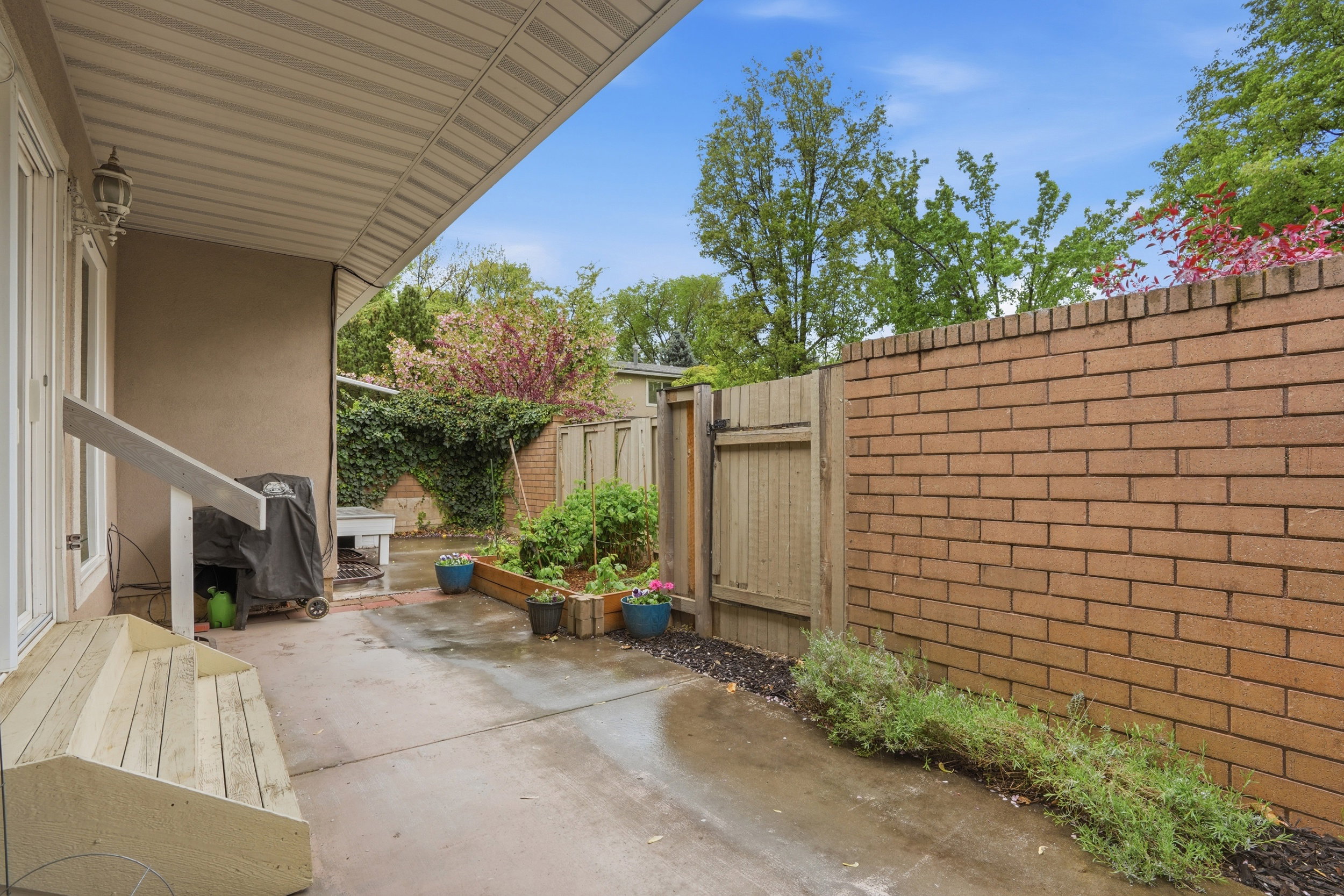 Fenced backyard with a patio area and grilling area