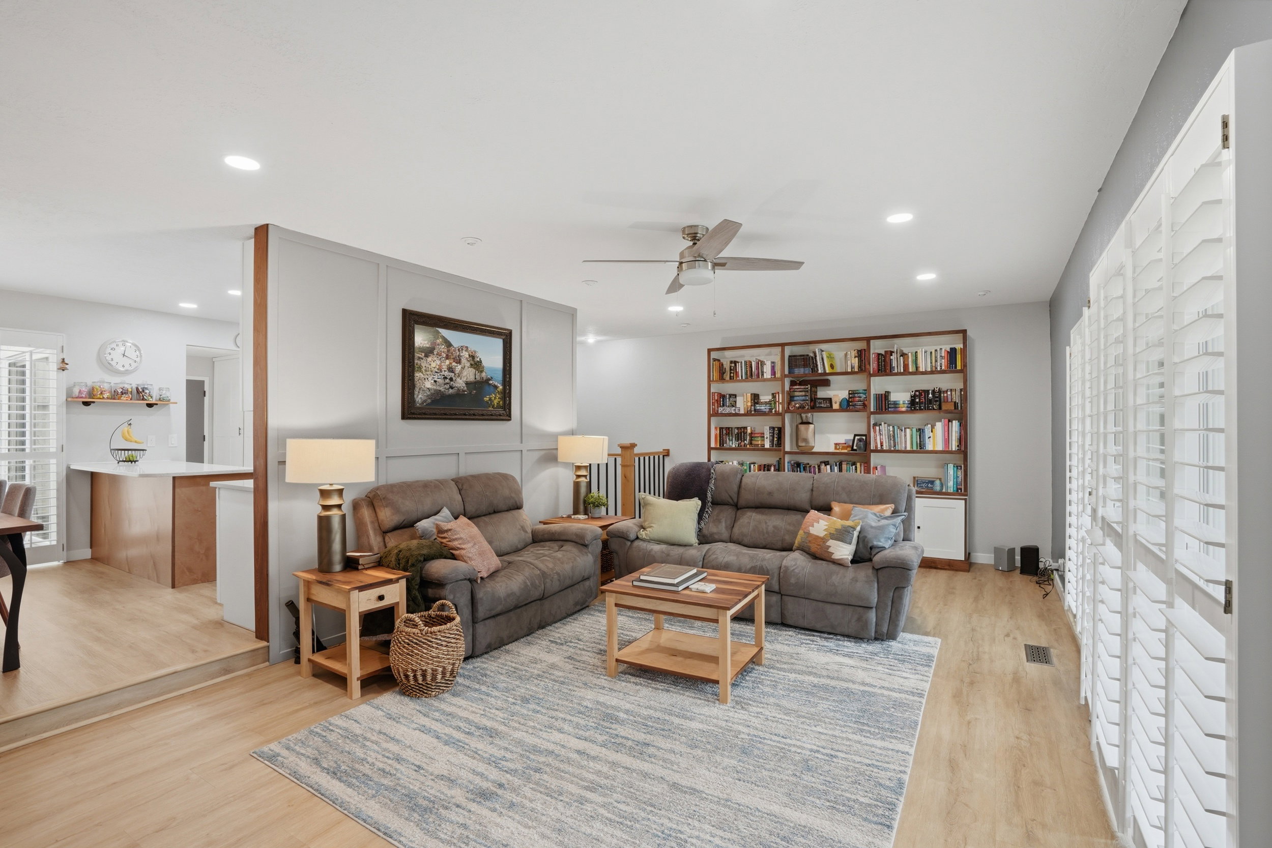 Living area featuring plenty of natural light, a ceiling fan, light wood-style floors, and recessed lighting