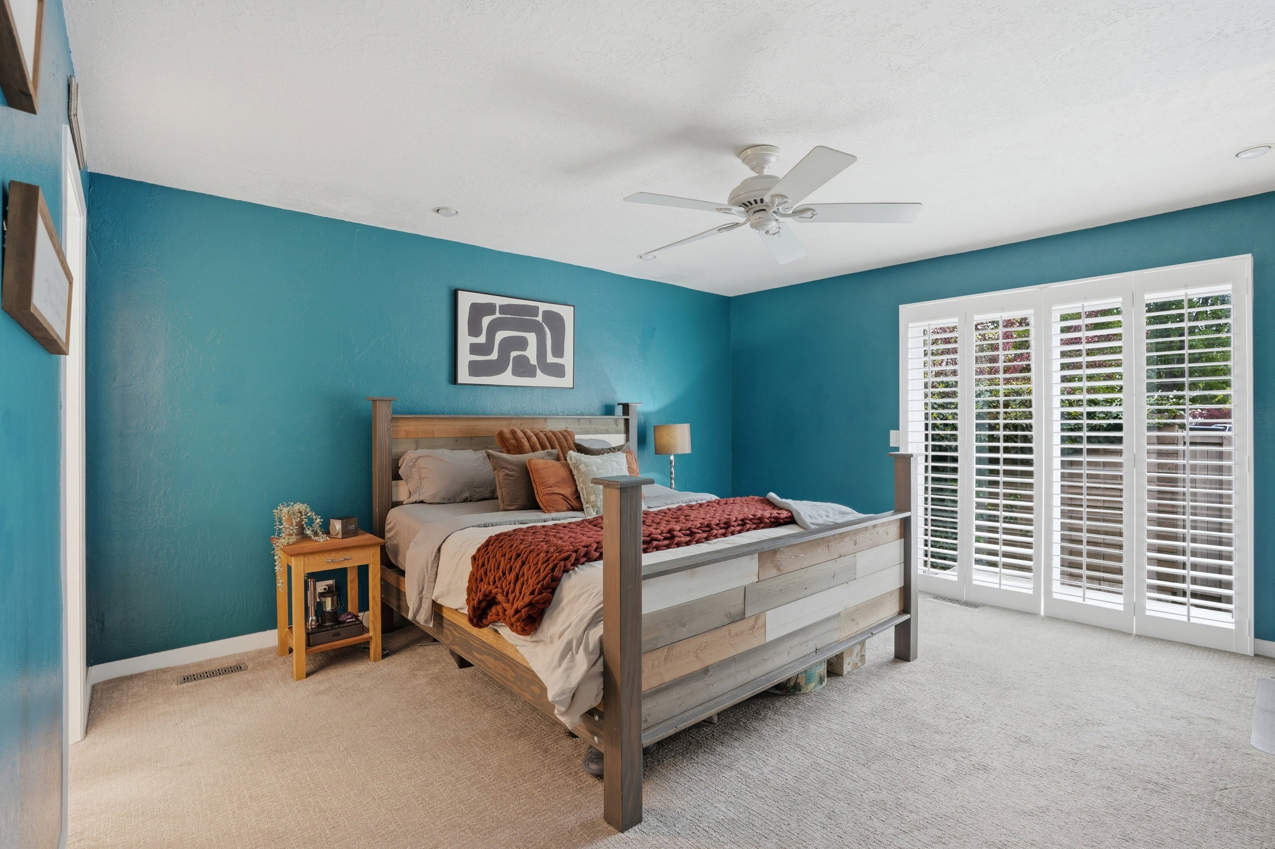 Bedroom featuring light colored carpet and ceiling fan