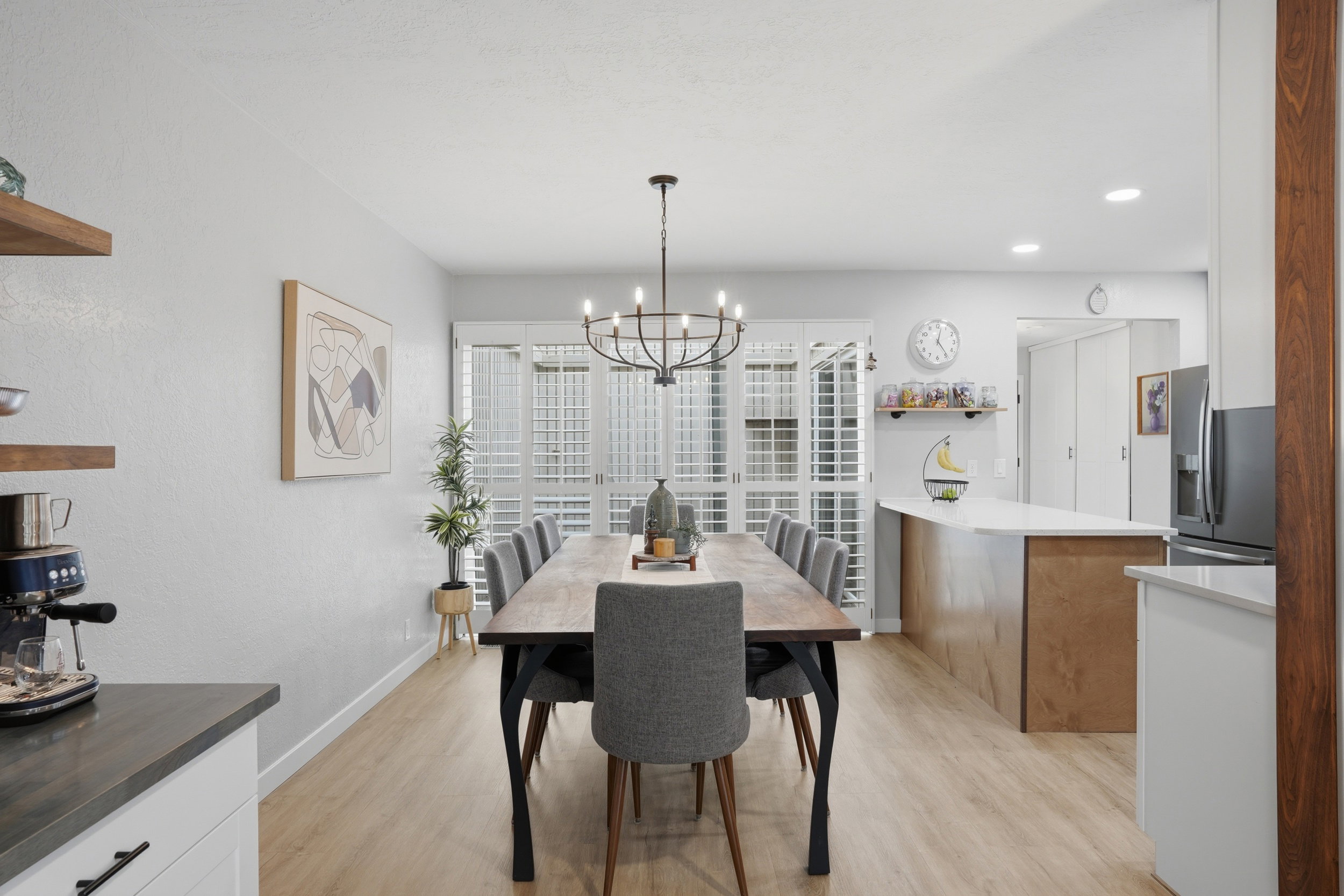 Dining area with light wood-style floors and hanging lights
