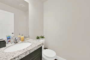 Bathroom featuring vanity and toilet