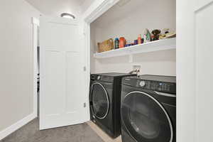 Laundry area with washing machine and dryer and a textured ceiling