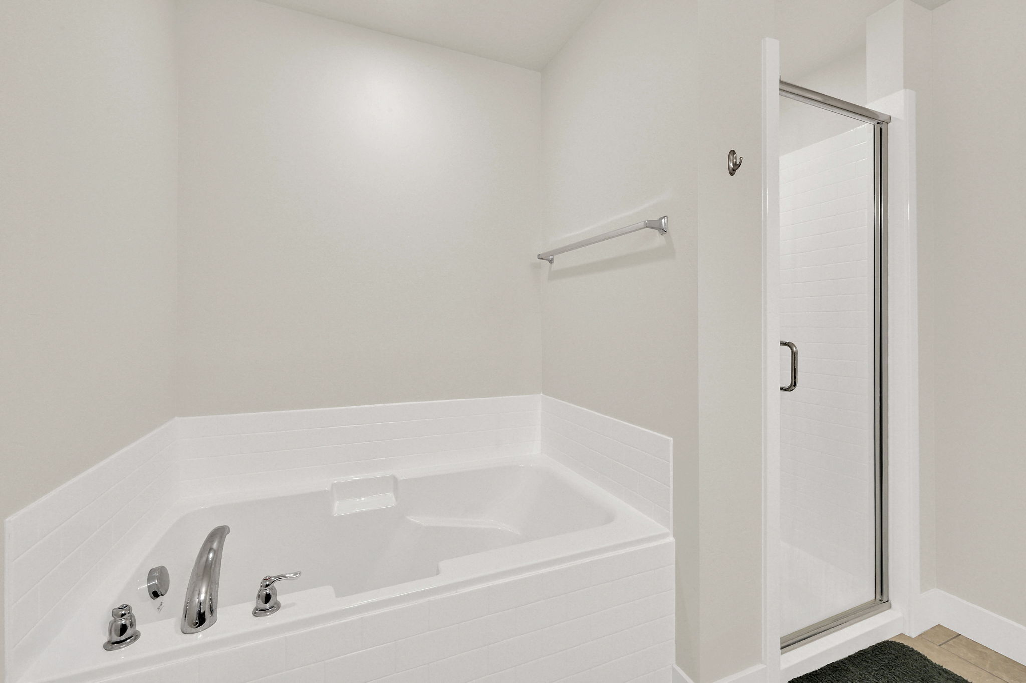 Bathroom featuring a stall shower and a bath