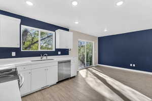 Kitchen with white cabinets, dishwasher, light wood-style floors, range with electric stovetop, and recessed lighting