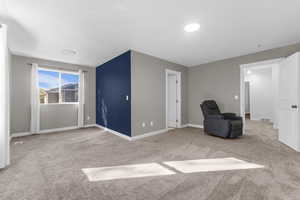 Unfurnished room with light carpet and baseboards