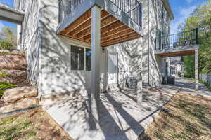 View of side of home with a patio, a balcony, and stucco siding