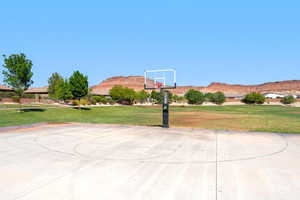 View of sport court featuring a mountain view, a lawn, and community basketball court