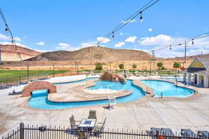 Community pool featuring a patio area and a mountain view