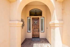 Doorway to property with stucco siding