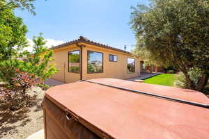 Rear view of house with a patio and stucco siding