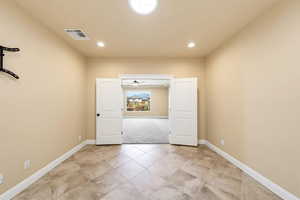 Spare room featuring light tile patterned floors, light carpet, and recessed lighting
