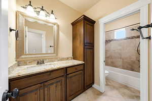 Bathroom featuring vanity and shower / bathtub combination