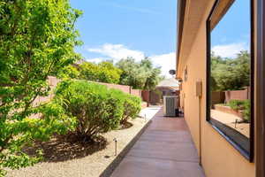 View of side of property featuring a fenced backyard and a gate