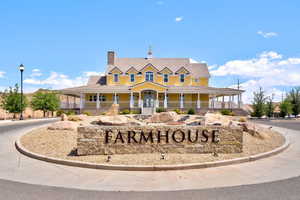 View of front of house featuring a porch, a chimney, and a tiled roof