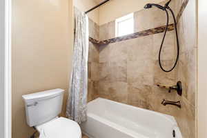 Full bathroom with toilet and shower / tub combo