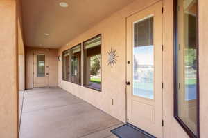 Property entrance featuring a patio and stucco siding