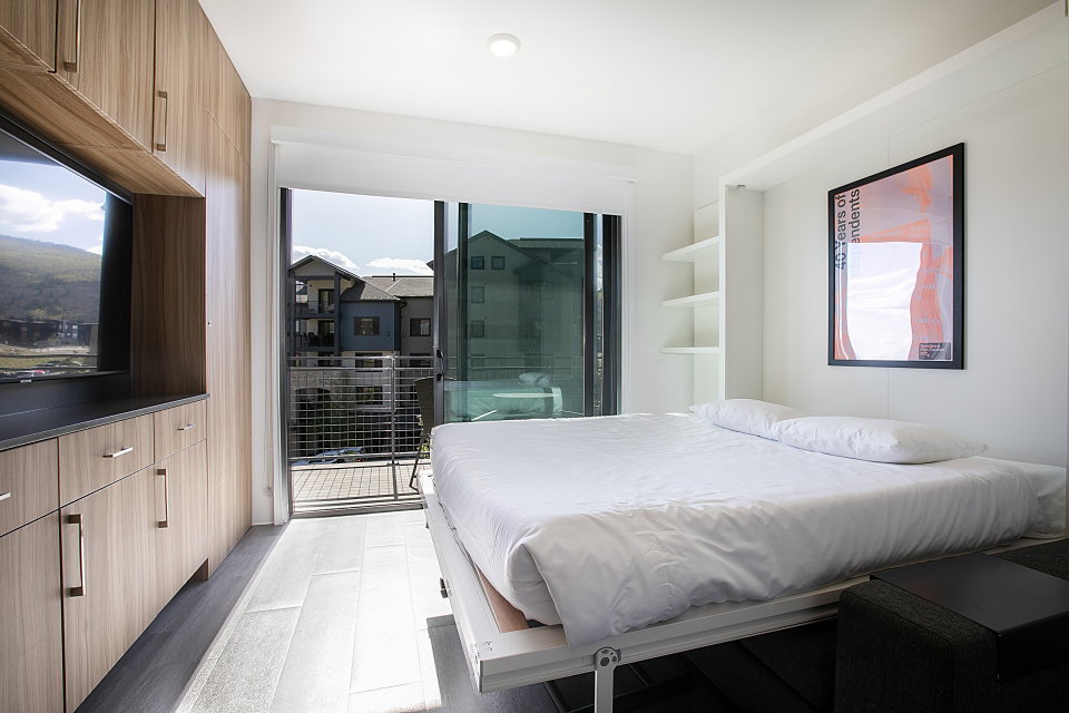 Bedroom with access to outside and light wood finished floors