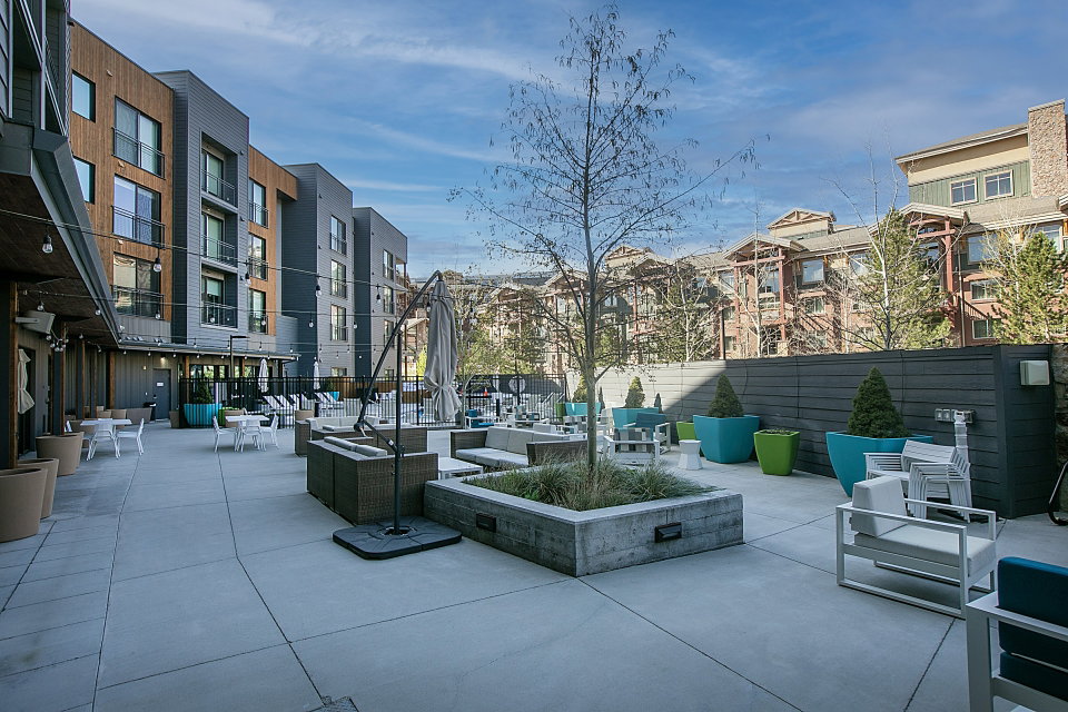 View of home's community with an outdoor lounge area and a patio area