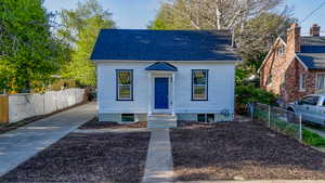 Bungalow-style home featuring concrete driveway and a shingled roof