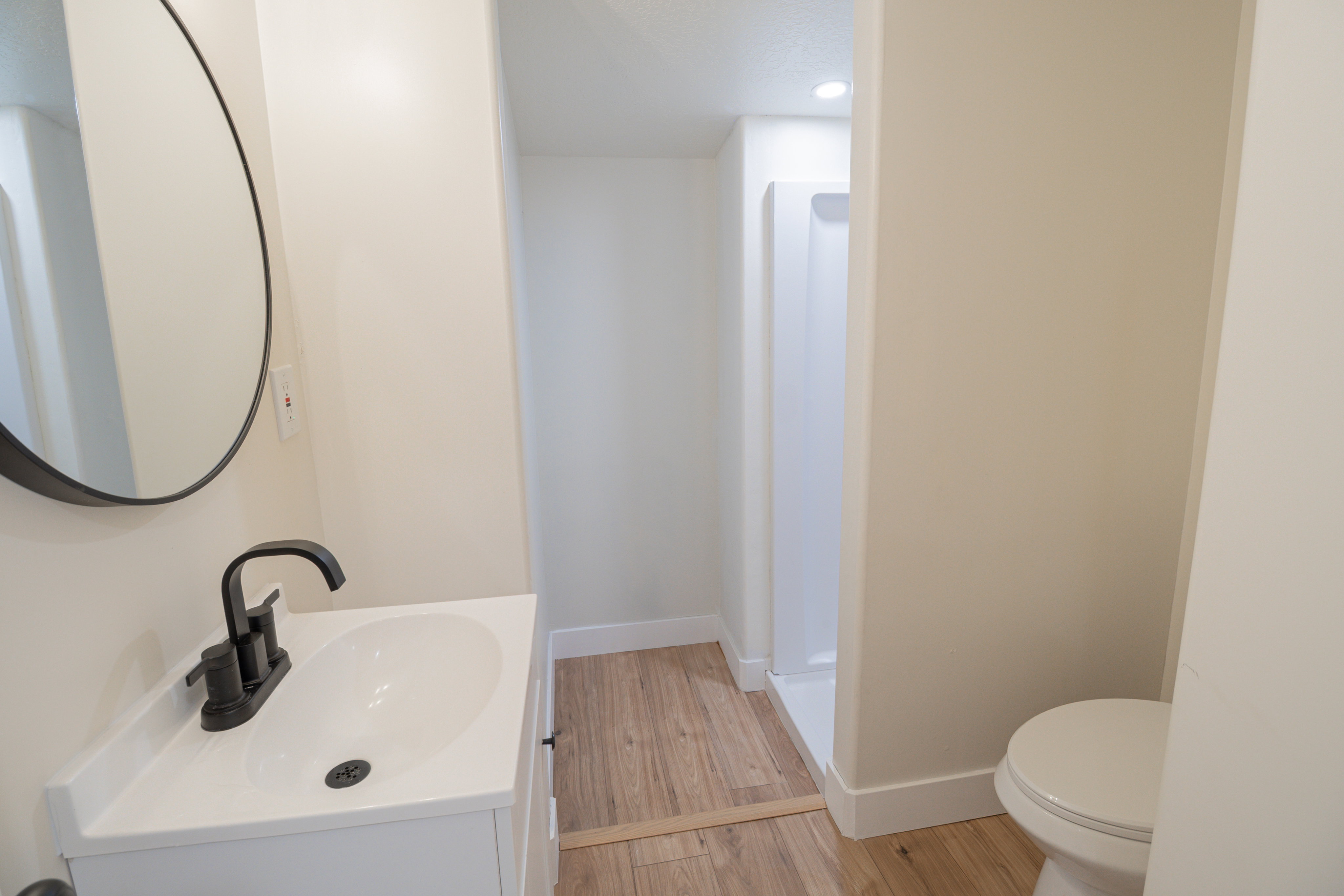 Full bathroom with vanity, light wood finished floors, and recessed lighting