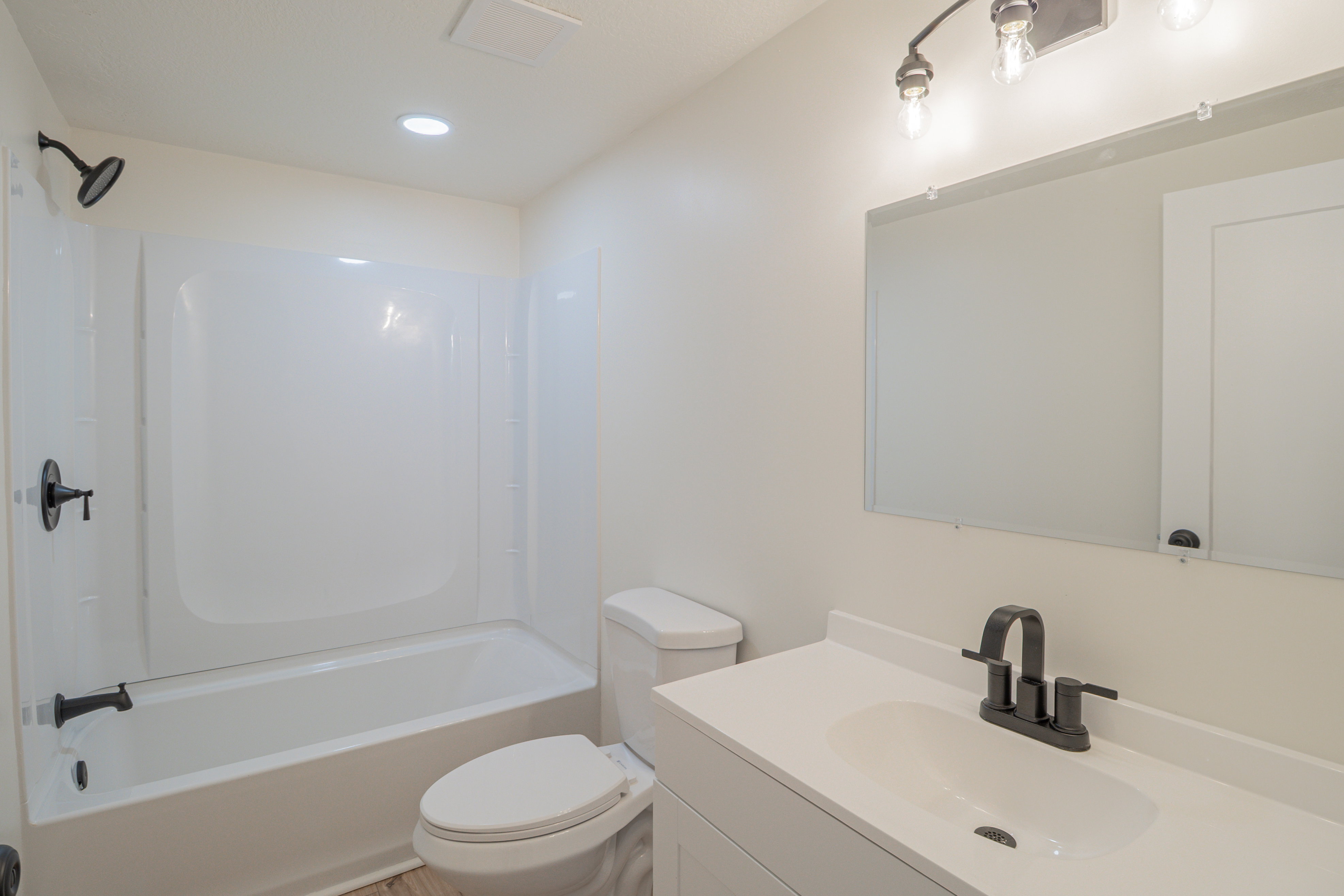 Full bathroom with vanity, bathing tub / shower combination, and recessed lighting