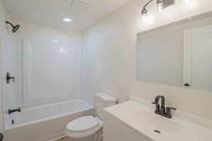 Full bathroom with vanity, bathing tub / shower combination, and recessed lighting