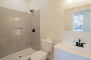 Full bath with vanity and a tile shower