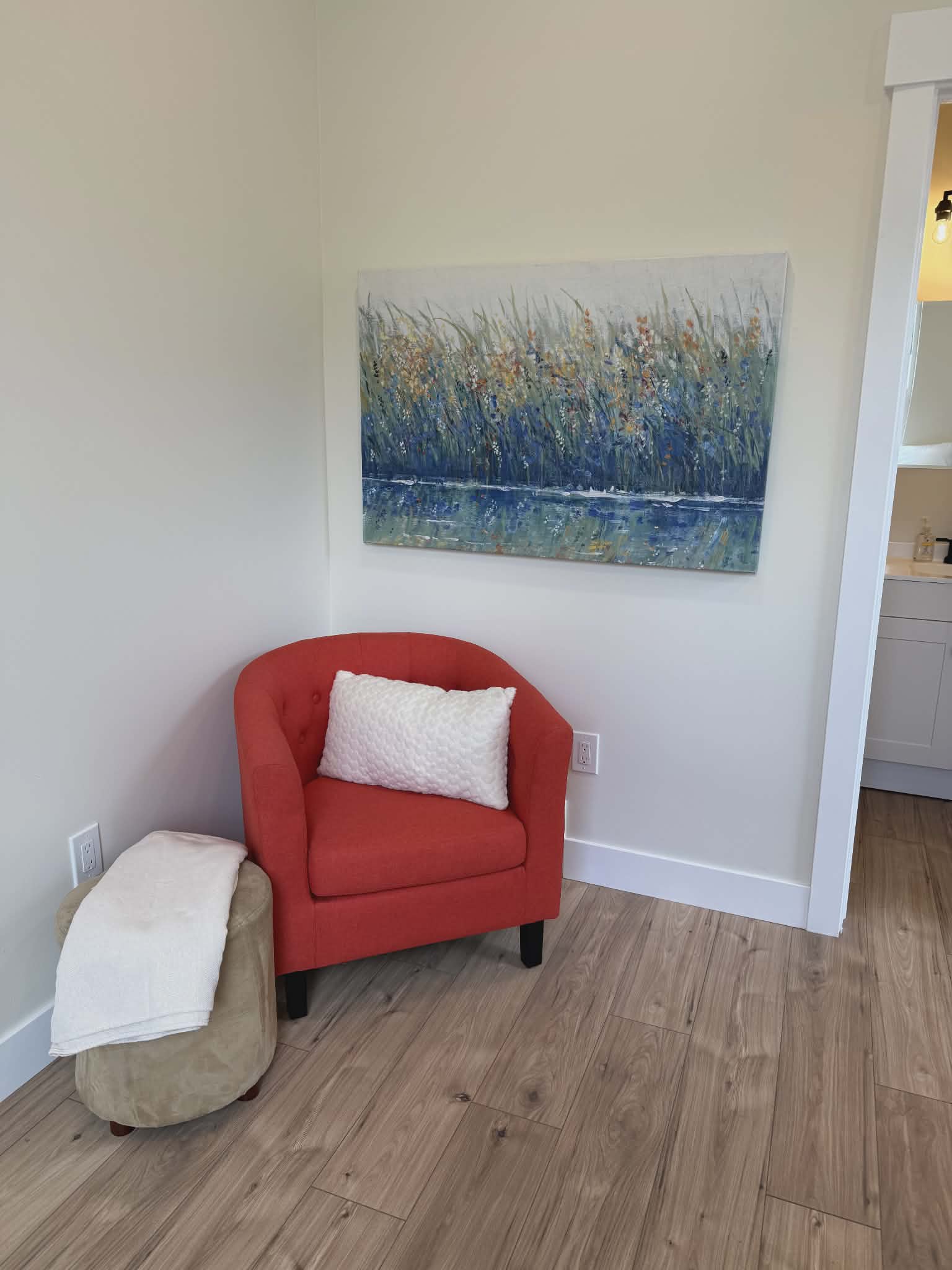 Light wood-finish flooring with crisp white baseboards