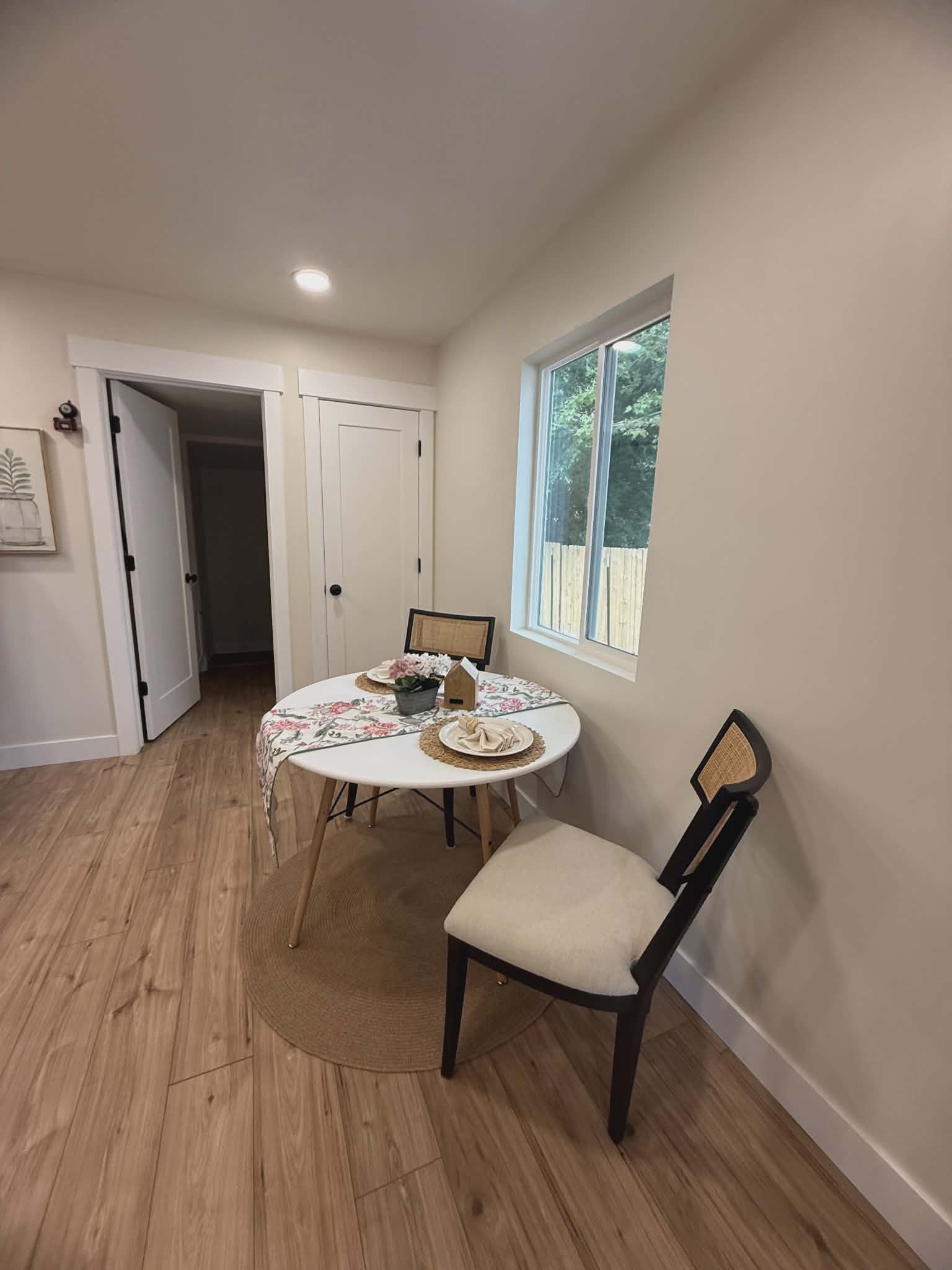 Light-toned wood-finish flooring complements neutral wall tones