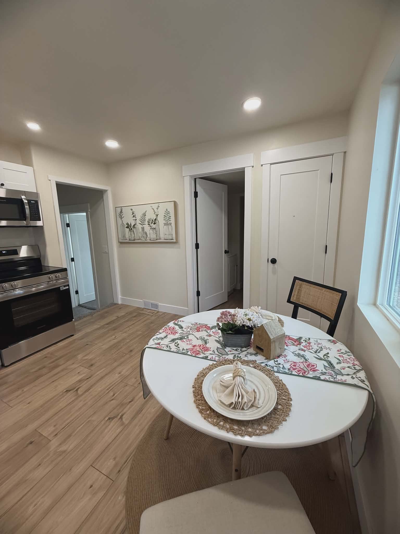 Kitchen space featuring wood-finish flooring, recessed lighting, and a window with natural light