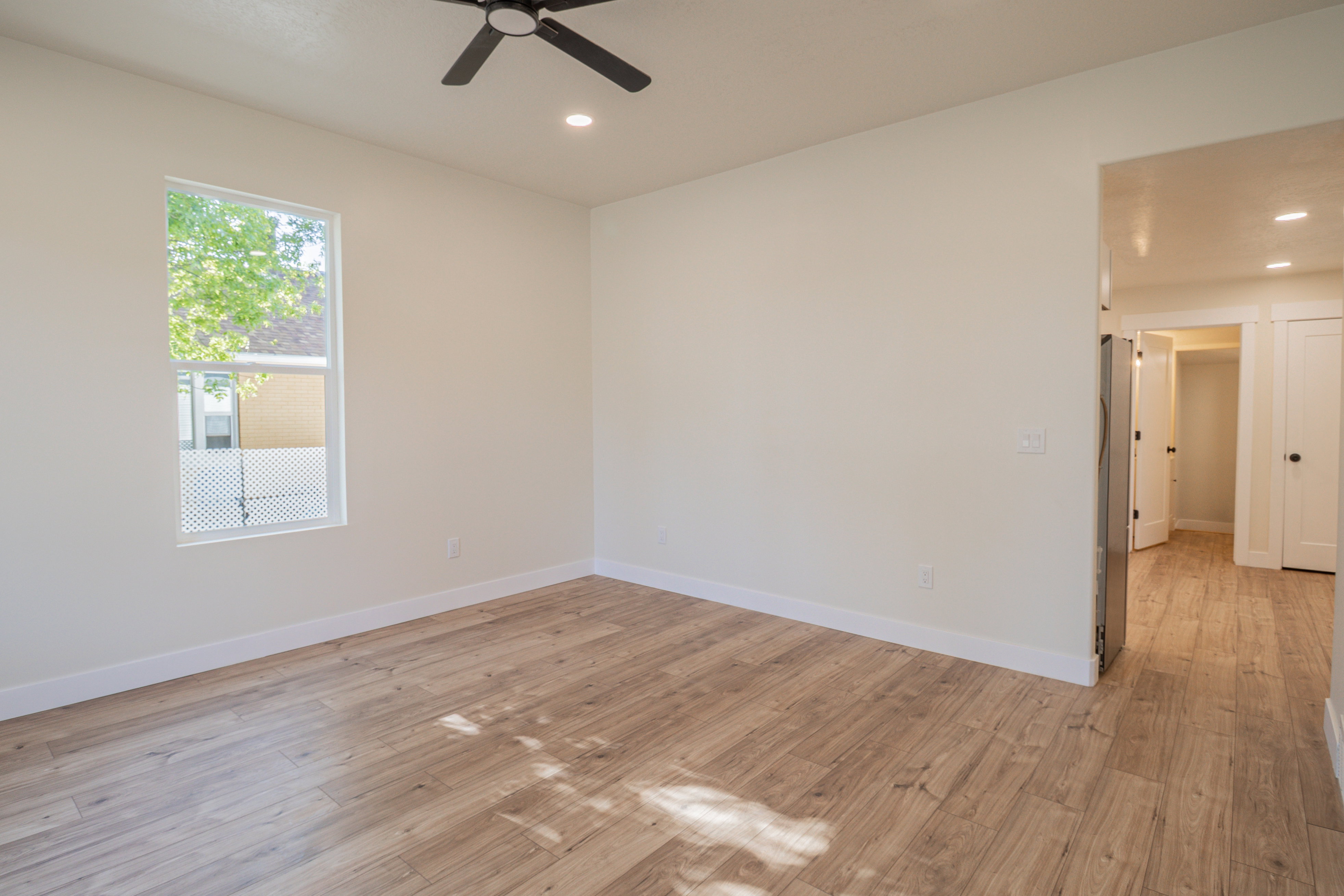 Spare room featuring light wood-type flooring, recessed lighting, and a ceiling fan
