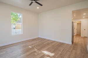 Spare room featuring light wood-type flooring, recessed lighting, and a ceiling fan