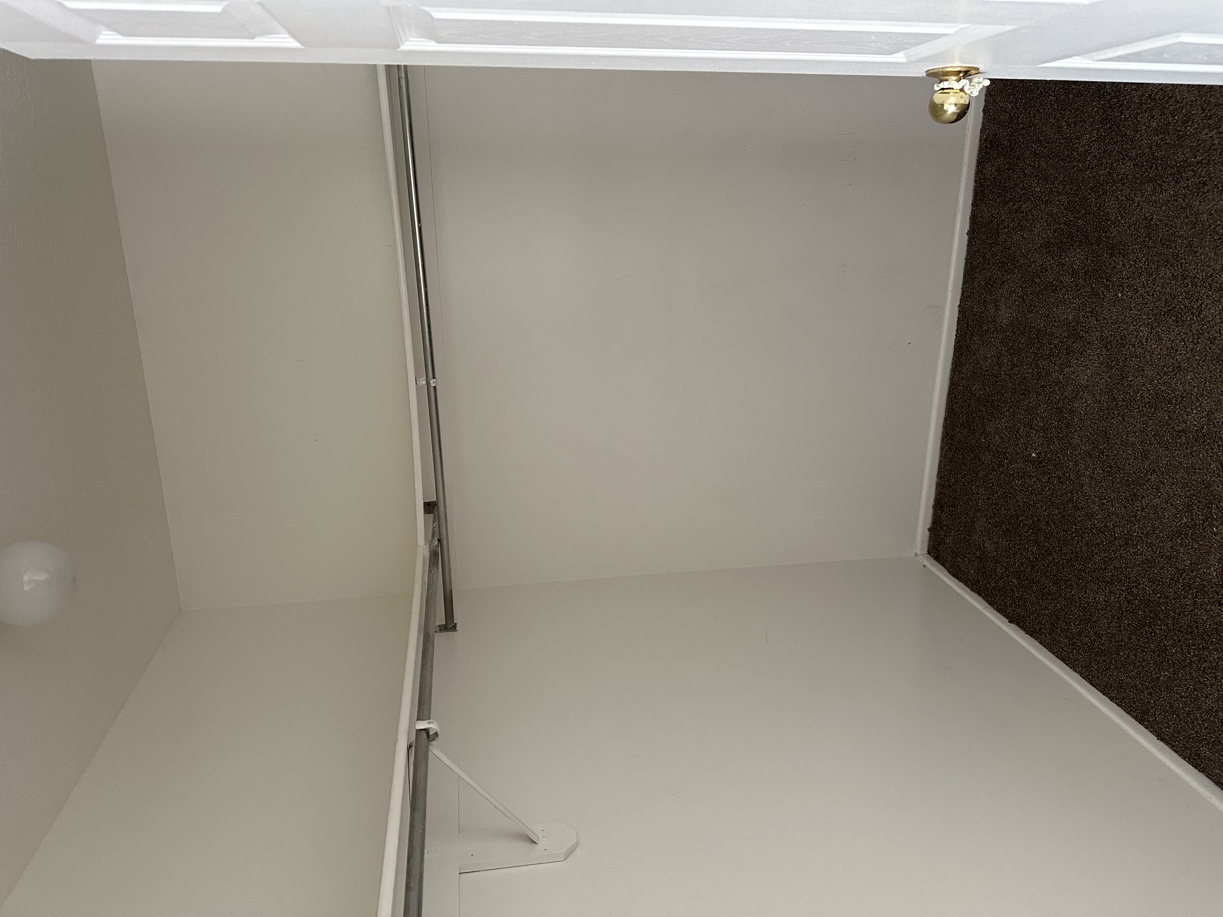 Walk in closet featuring dark colored carpet